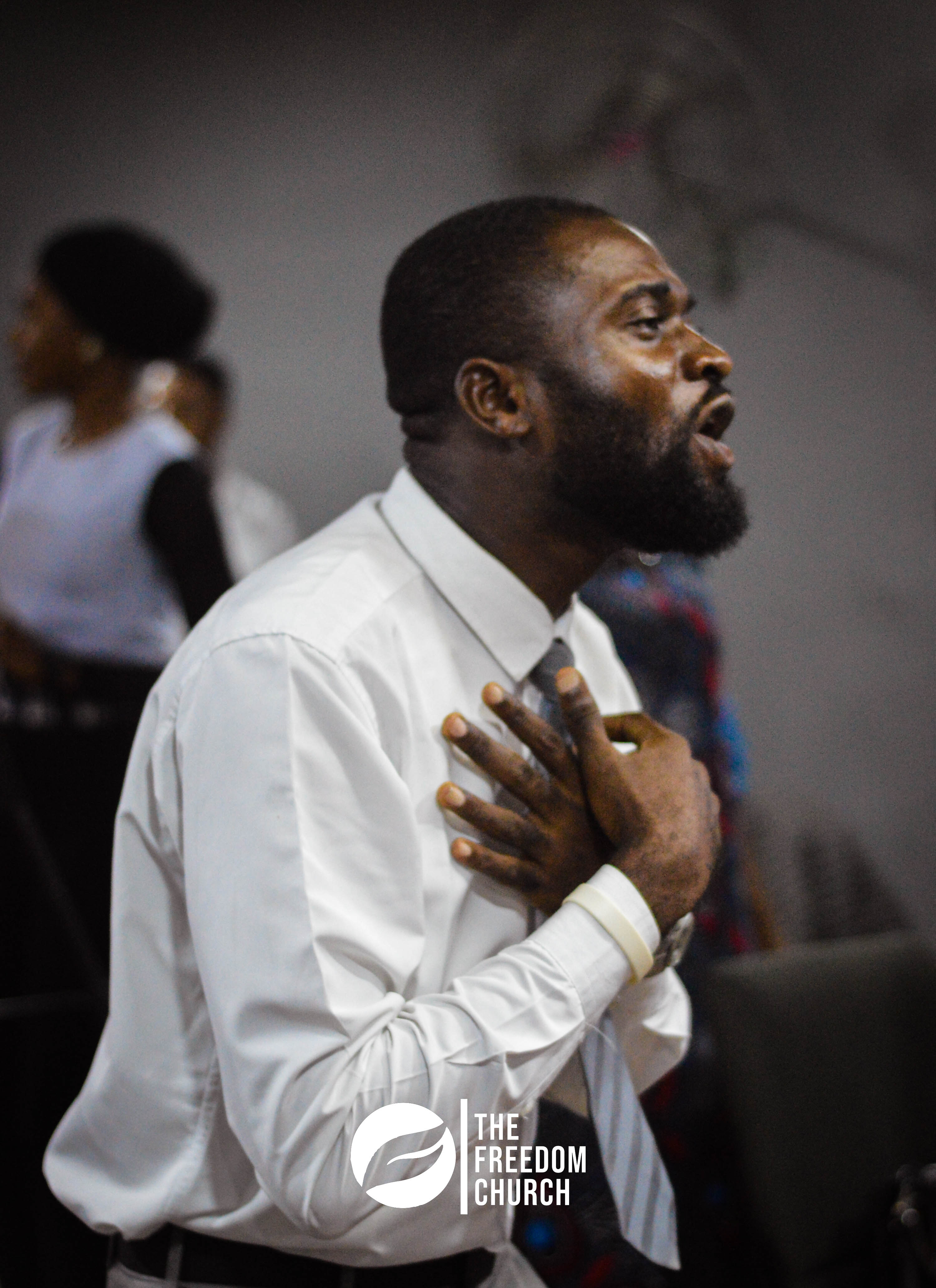 A member worshipping with hand over heart