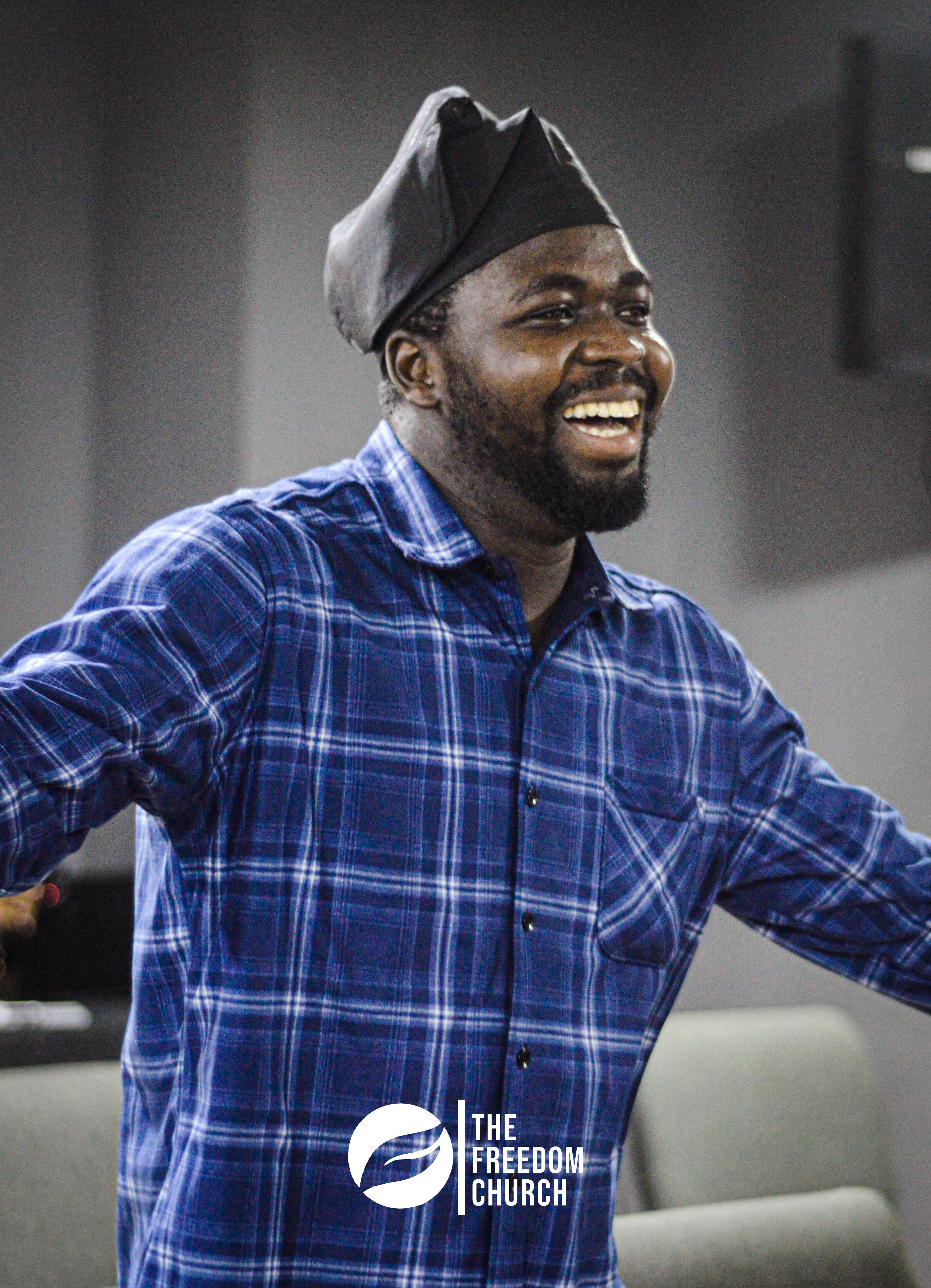 A member smiling and dancing at Freedom Church