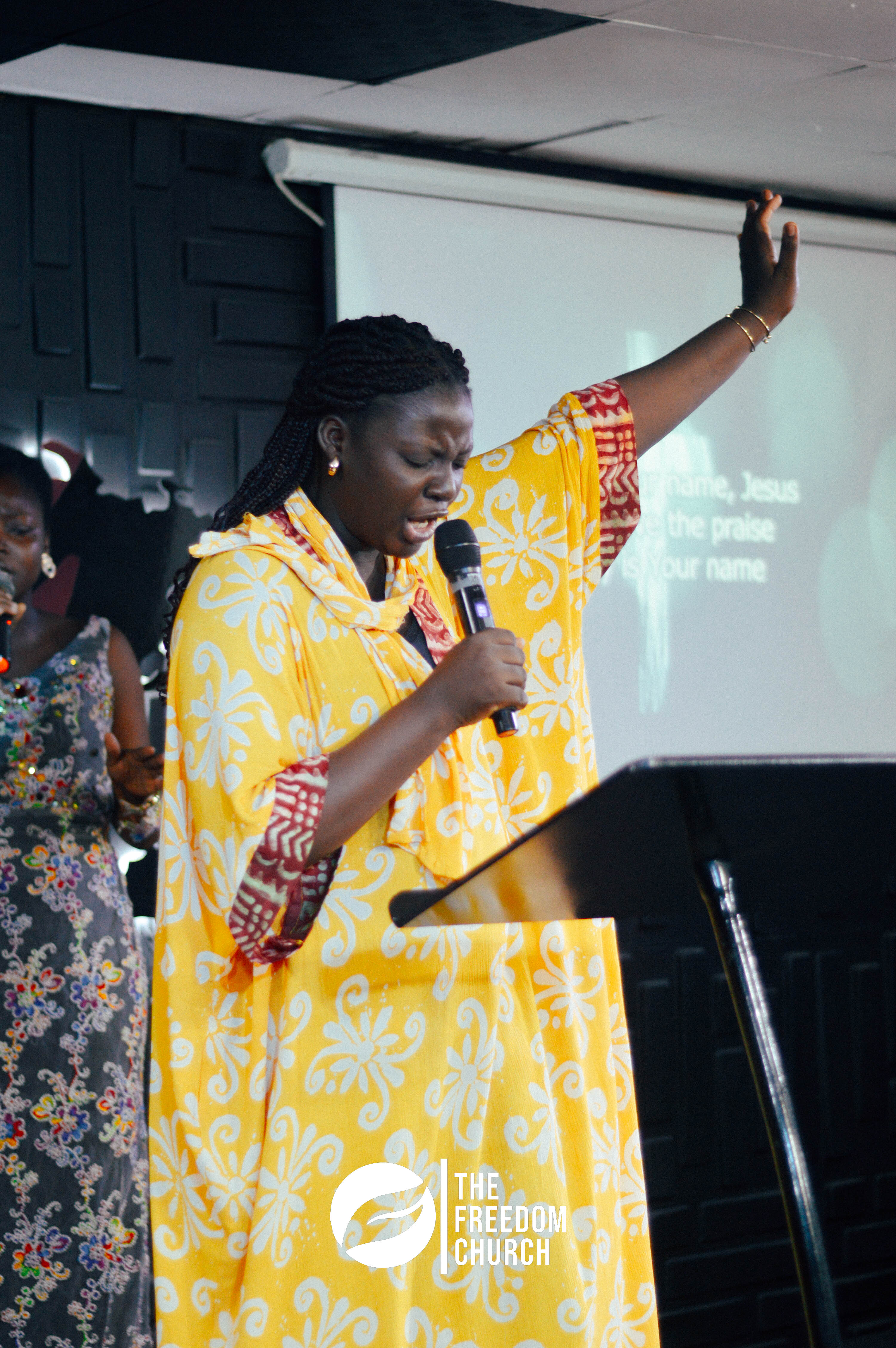 A member worshipping with hands raised during service