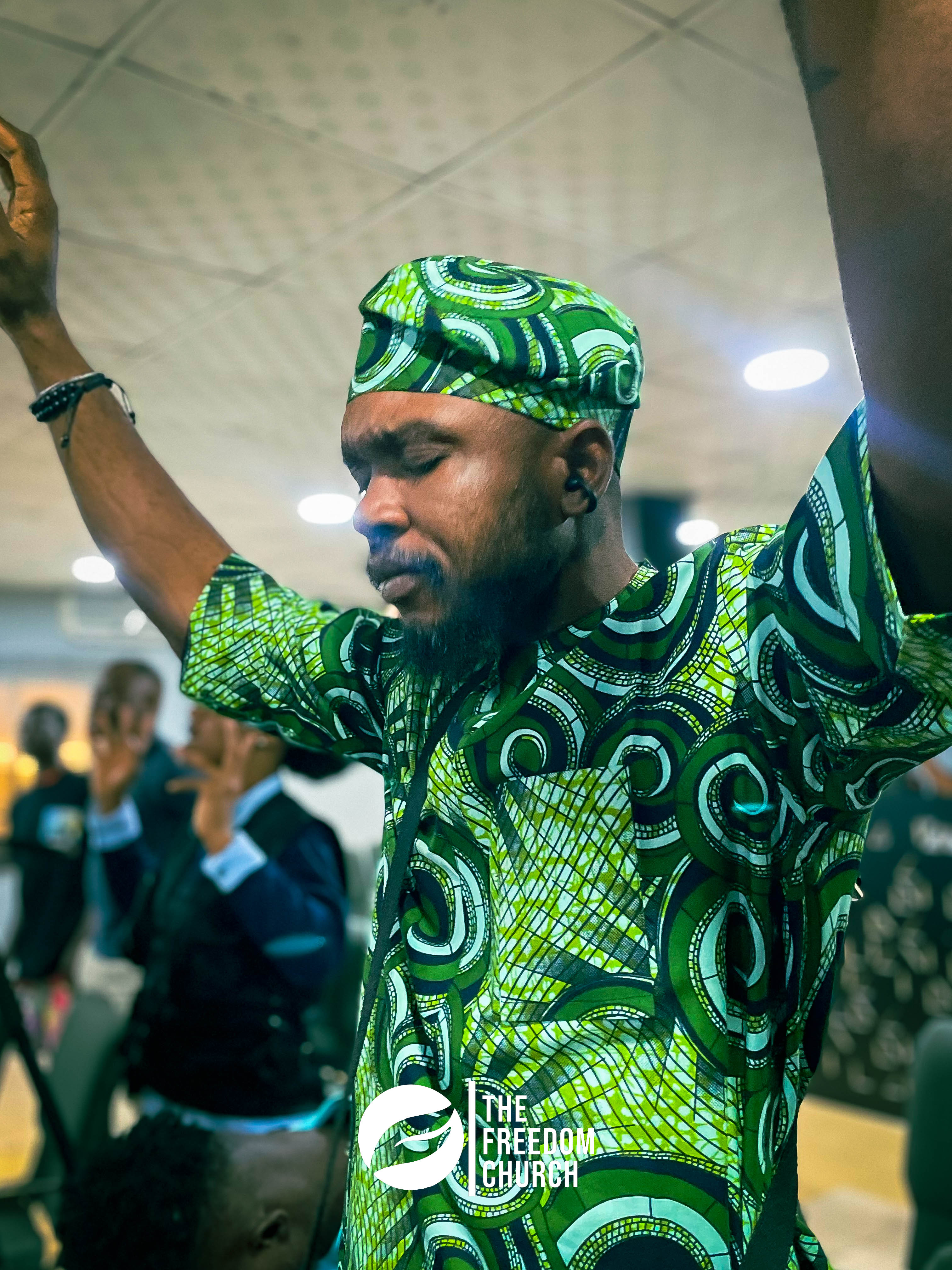 A member worshipping in traditional attire