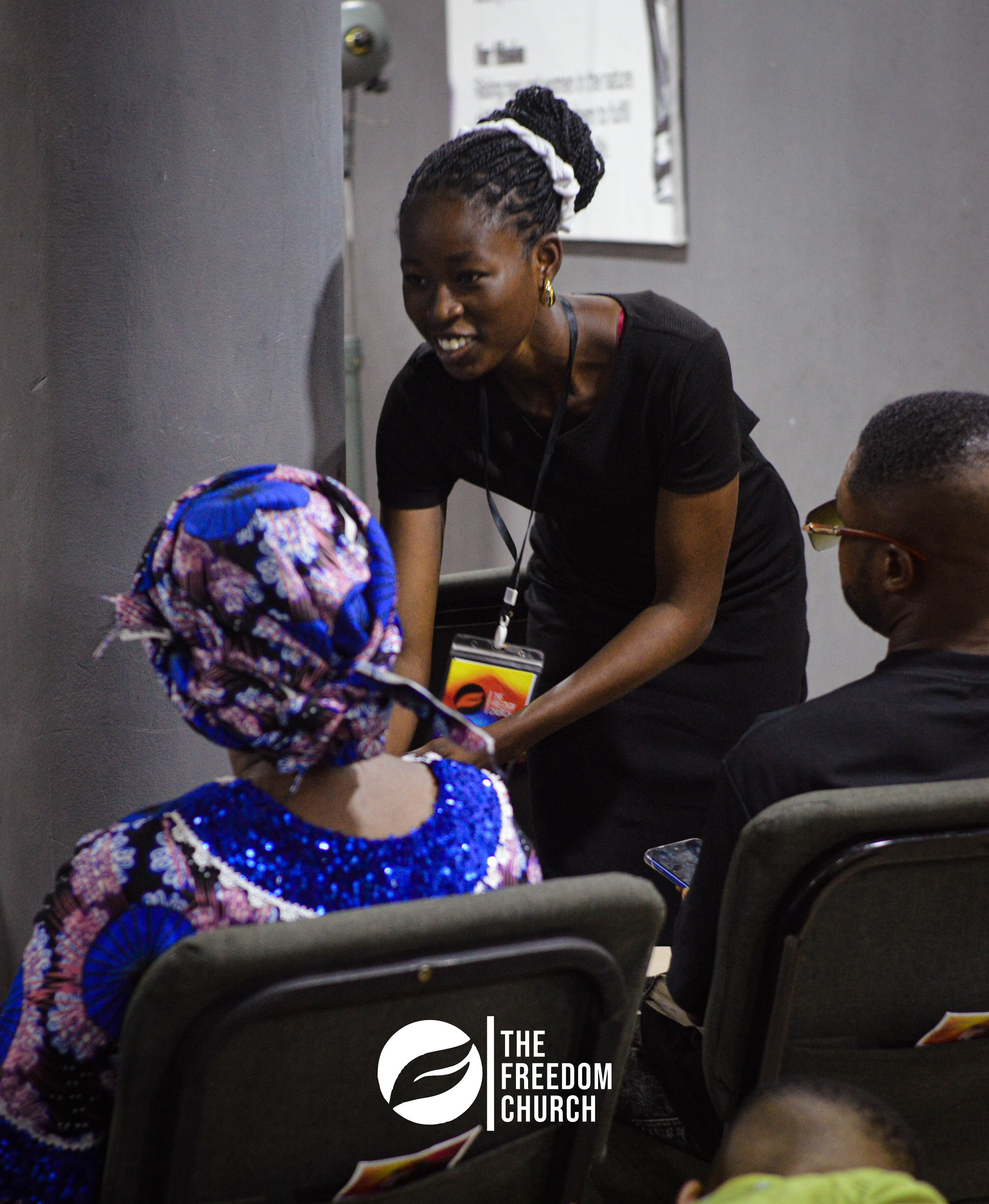 A volunteer welcoming a member at Freedom Church