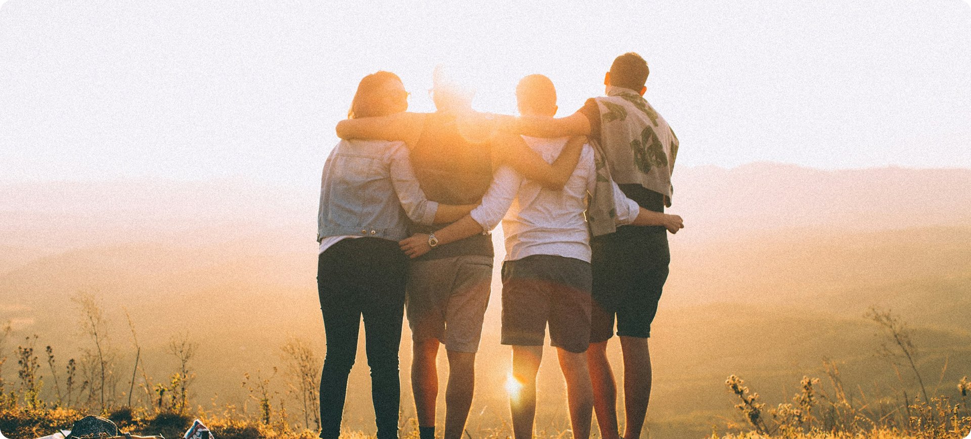 Members of The Freedom Church standing together at sunset